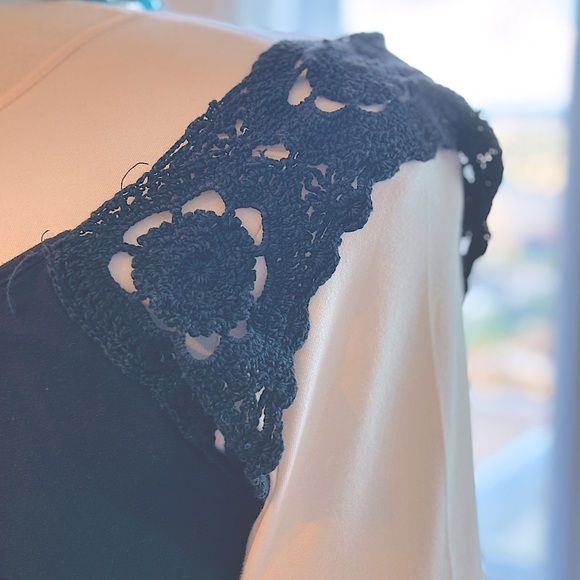 Black shirt with short sleeves. Sleeves are hand crocheted flowers. - Picture 1 of 4